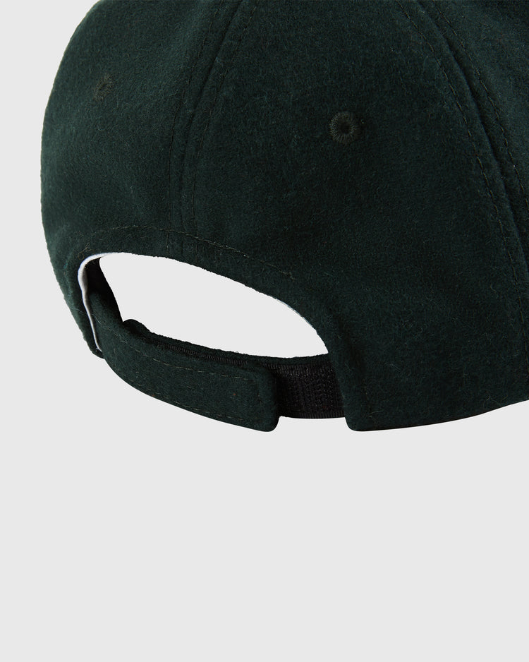Close-up of the Ebbets Field Los Angeles Angels (PCL) 1949 Youth Wool Ballcap in dark green, featuring a fabric strap with metal buckle for adjustment. Classic Pacific Coast League-inspired style. Plain white background.