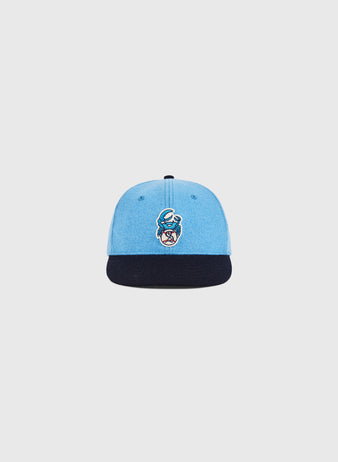 The Ebbets Field Santurce Cangrejeros Crab Wool Ballcap (Youth Size) is light blue with a dark blue brim and features an embroidered moon and stylized face logo, inspired by the legendary team, shown on a plain white background.