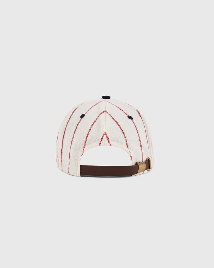 The Sam Adams Pinstripe Wool Ballcap by Ebbets Field features white wool with red pinstripes, seen from the back with a brown adjustable strap, brass buckle, and a dark top button.
