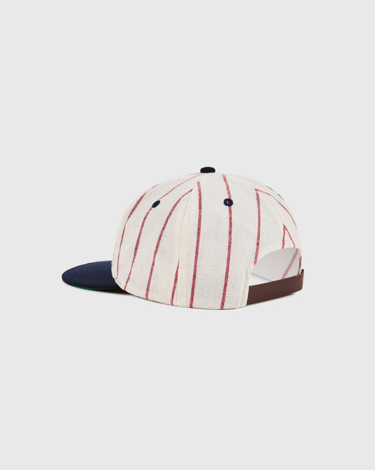 The Ebbets Field Sam Adams Pinstripe Wool Ballcap features a cream crown with red pinstripes, navy brim, black button, and an adjustable brown strap. Shown from the rear and slightly to the side.