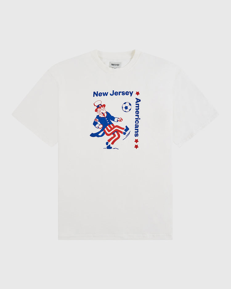Show your love for American soccer with the Ebbets Field New Jersey Americans Short Sleeve Graphic T-Shirt—featuring Uncle Sam kicking a soccer ball and blue and red stars on a classic white tee.