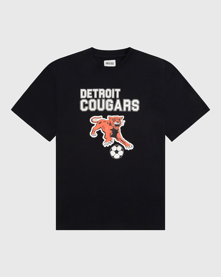 Show your soccer pride with the Detroit Cougars Short Sleeve Graphic T-Shirt by Ebbets Field—a black tee featuring bold white DETROIT COUGARS text above an orange cougar pouncing on a soccer ball.