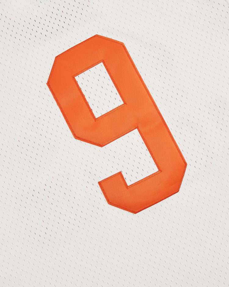 The Ebbets Field Dallas Tornado Mesh Soccer Jersey features a bold orange number 9 on white mesh, capturing the classic look of historic athletic shirts.