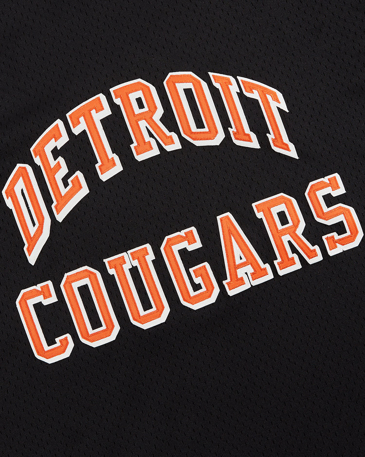 The Detroit Cougars Mesh Soccer Jersey by Ebbets Field features black mesh with bold orange and white DETROIT COUGARS lettering in a classic collegiate font—ideal vintage soccer apparel for fans and collectors.