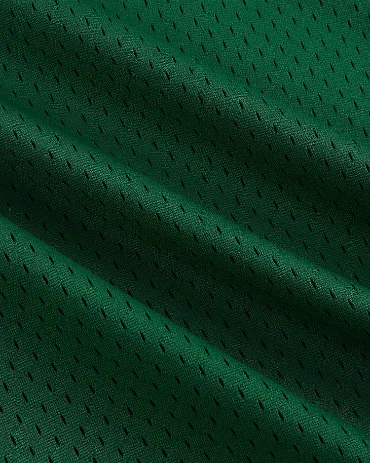 Close-up of the Ebbets Field San Francisco Golden Gate Gales Mesh Soccer Jersey shows green athletic mesh with small, evenly spaced holes and a textured, vintage-inspired pattern with soft folds and subtle shadows.