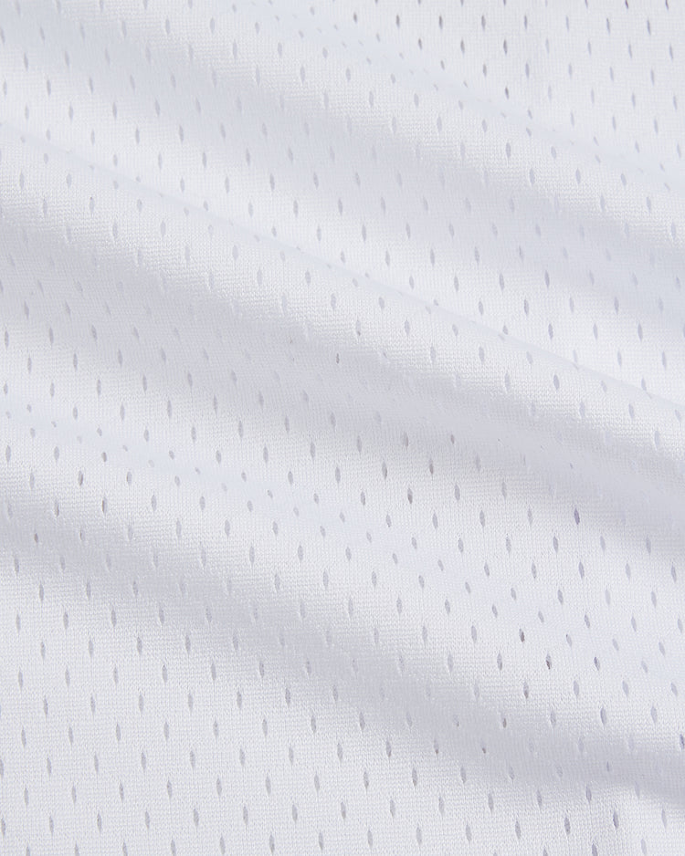 Close-up of the Birmingham Barons Frank Thomas Button Up Mesh Jersey by Ebbets Field, showing its soft white fabric with a pattern of small, evenly spaced perforations—typical of mesh material used in classic baseball jerseys. This textured design closely resembles the style worn by Frank Thomas during his time with the Birmingham Barons.
