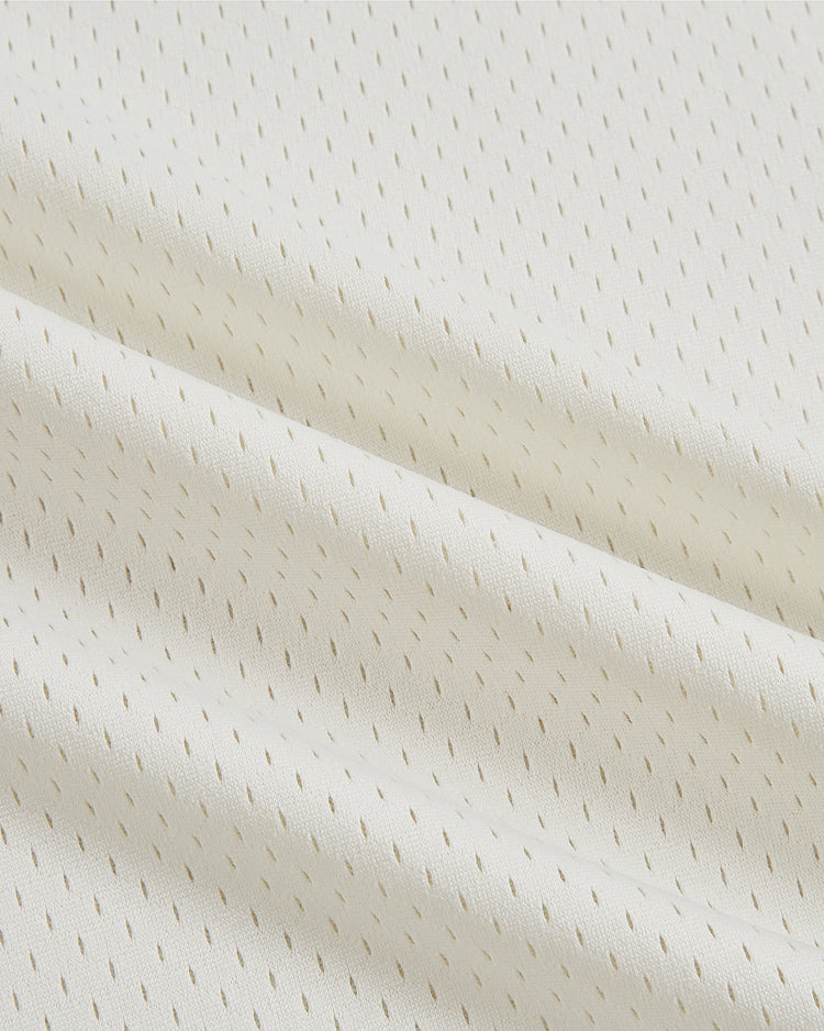 Close-up of the Ebbets Field Philadelphia Stars V-Neck Mesh Jersey, crafted from white fabric with small, evenly spaced perforations and gentle folds, evoking the soft, breathable mesh style iconic to classic sportswear from the Negro National League.