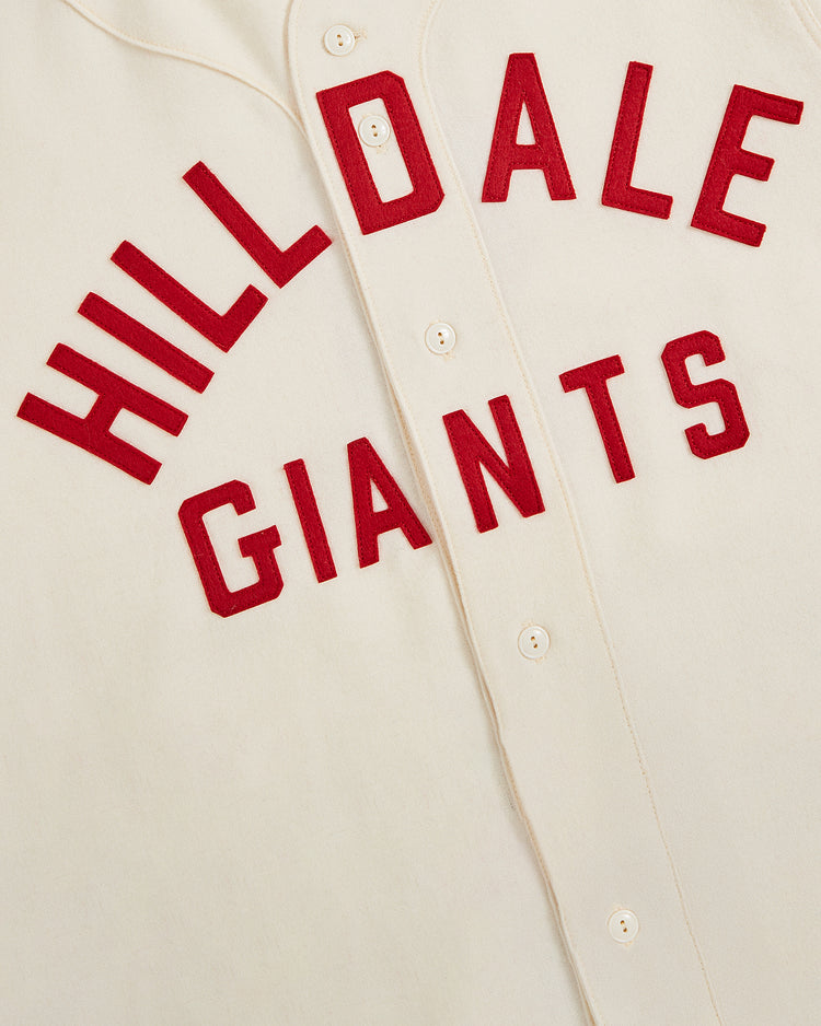 The Ebbets Field Hilldale Giants 1929 Wool Home Authentic Jersey features cream-colored authentic wool with red “HILLDALE GIANTS” lettering arched across the front and prominent center buttons, honoring Negro League baseball and capturing the iconic style of the 1929 Hilldale Giants.