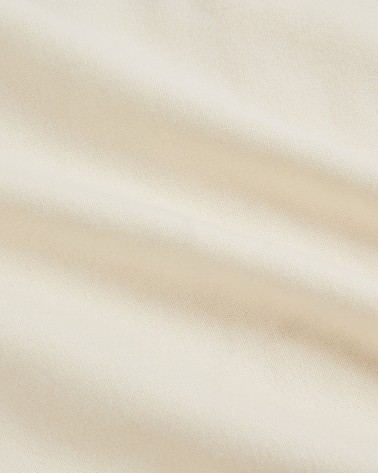 A close-up of the soft, cream-colored wool fabric from the Ebbets Field Hilldale Giants 1929 Wool Home Authentic Jersey, showcasing gentle folds and a smooth texture.