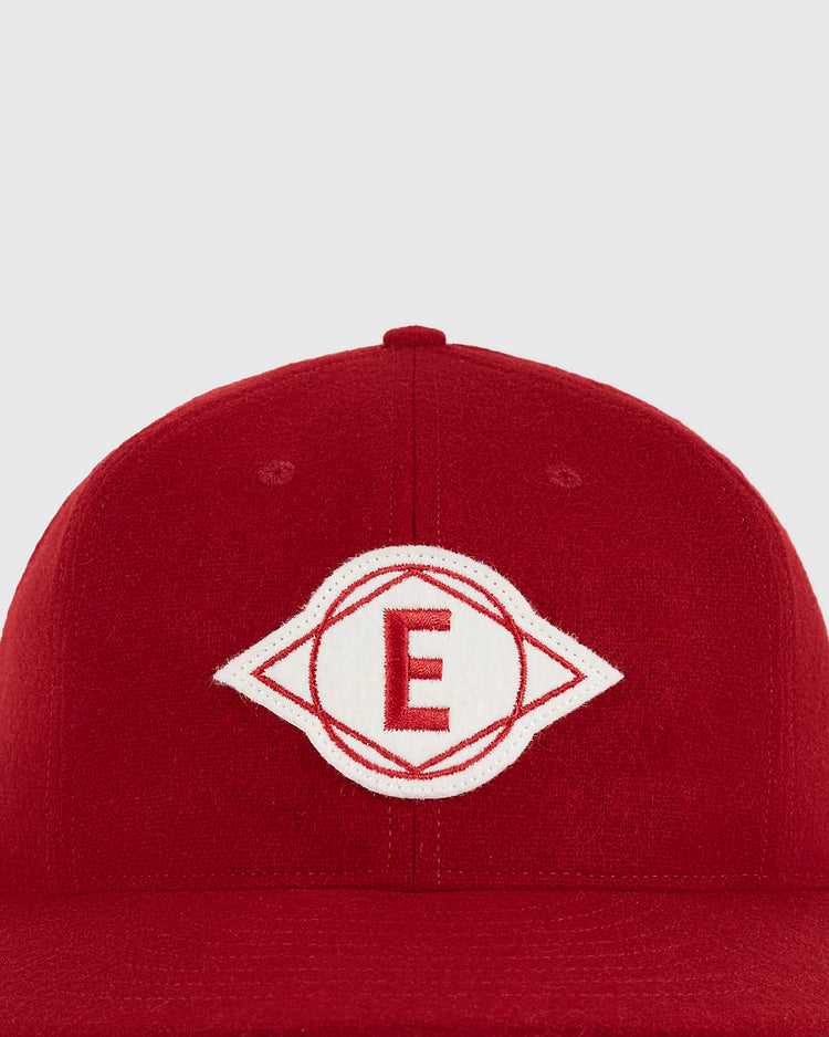 The Escogido Leones 1955 Authentic Wool Ballcap by Ebbets Field is a red baseball cap with a white embroidered emblem featuring a red letter 