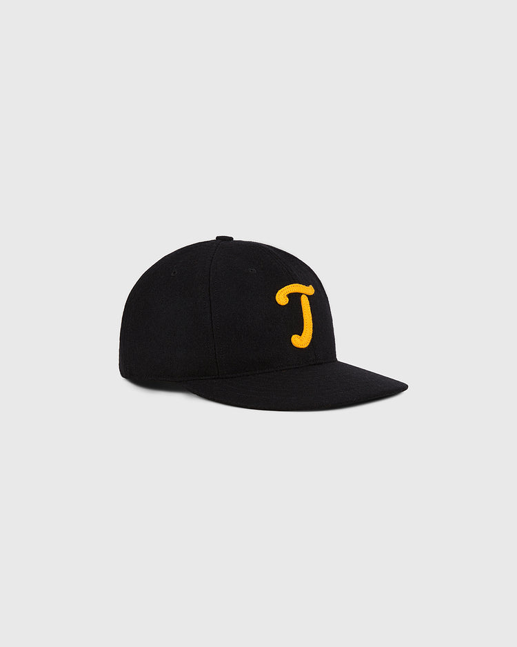 The Ebbets Field Mexico City Tigres 1959 Authentic Wool Ballcap, featuring a black design with a yellow embroidered letter J on the front, is displayed against a plain light gray background.