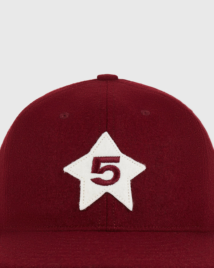 A close-up of the Cordoba Cafeteros 1958 Authentic Wool Ballcap by Ebbets Field, featuring a white star patch with the number 5 embroidered in red on the front.