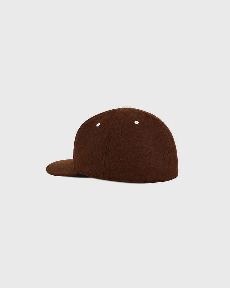A side and back view of the Cordoba Cafeteros Authentic Wool Ballcap by Ebbets Field, featuring a plain brown design with two small white eyelets on the crown and a flat brim, displayed against a light gray background.