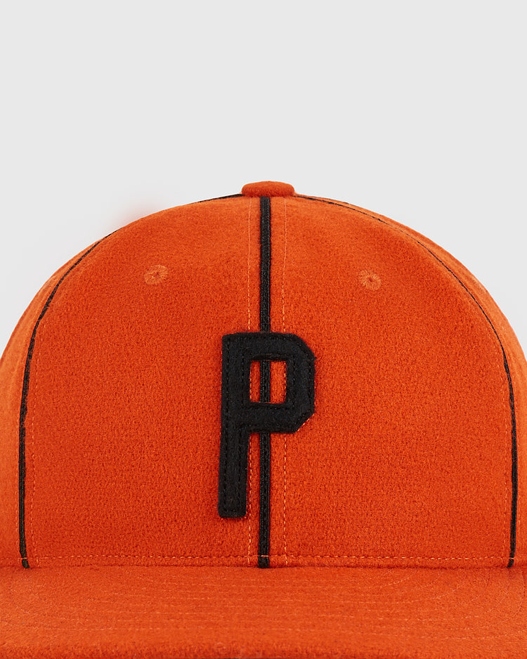 A Ponce Leones 1951 Authentic Wool Ballcap by Ebbets Field, featuring an orange wool design with black stripes and a prominent black letter 'P' embroidered on the front, displayed against a plain white background.