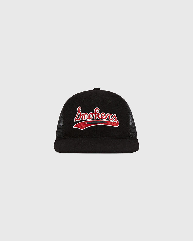 The Tampa Bay Smokers Mesh Trucker Ballcap by Ebbets Field features “Smokers” in red and white script on the front, shown from the front against a light gray background.