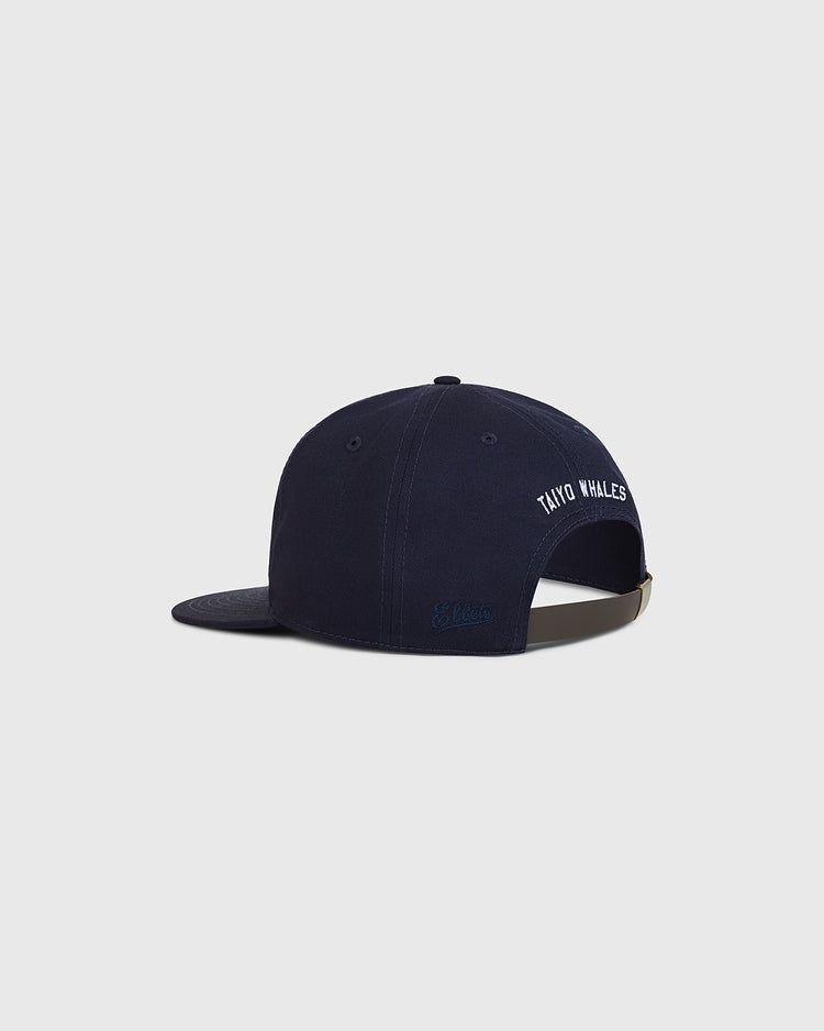 A back view of the Ebbets Field Taiyo Whales Cotton Twill Ballcap in navy blue, featuring “Taiyo Whales” embroidered in white above the adjustable strap, inspired by classic Japanese baseball hats.