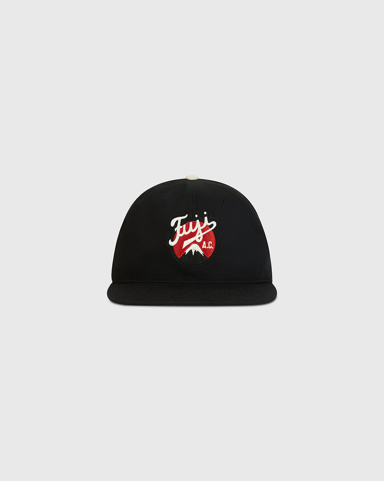 The Ebbets Field Fuji Athletic Club Cotton Twill Ballcap is a black flat-brim cap crafted from cotton twill, showcasing a red and white embroidered Fuji Athletic Club logo with a mountain graphic on the front—a homage to Japanese American baseball heritage. Set against a plain light gray background.