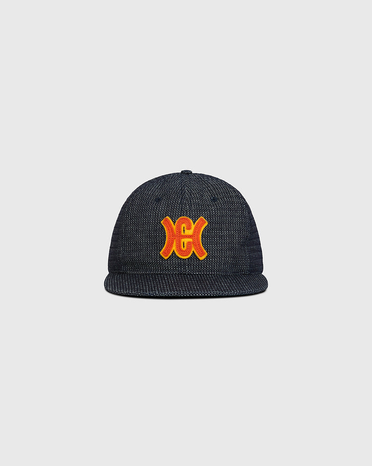 Ebbets Field Hiroshima Carp Japanese Indigo Cotton Dobby Ballcap in dark blue indigo-dyed cotton with a flat brim and an orange and yellow embroidered logo on the front.