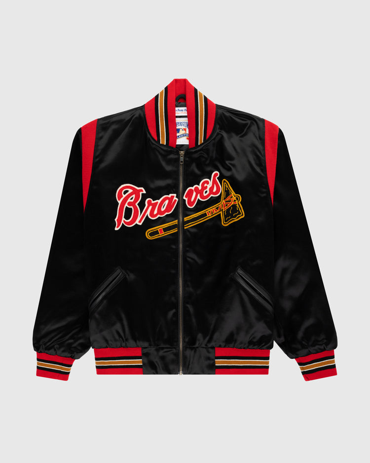The EFF Milwaukee Braves 1957 Authentic All Satin Varsity Jacket features black satin with red and yellow accents, Braves in red script, a yellow tomahawk graphic, and striped cuffs, collar, and waistband.