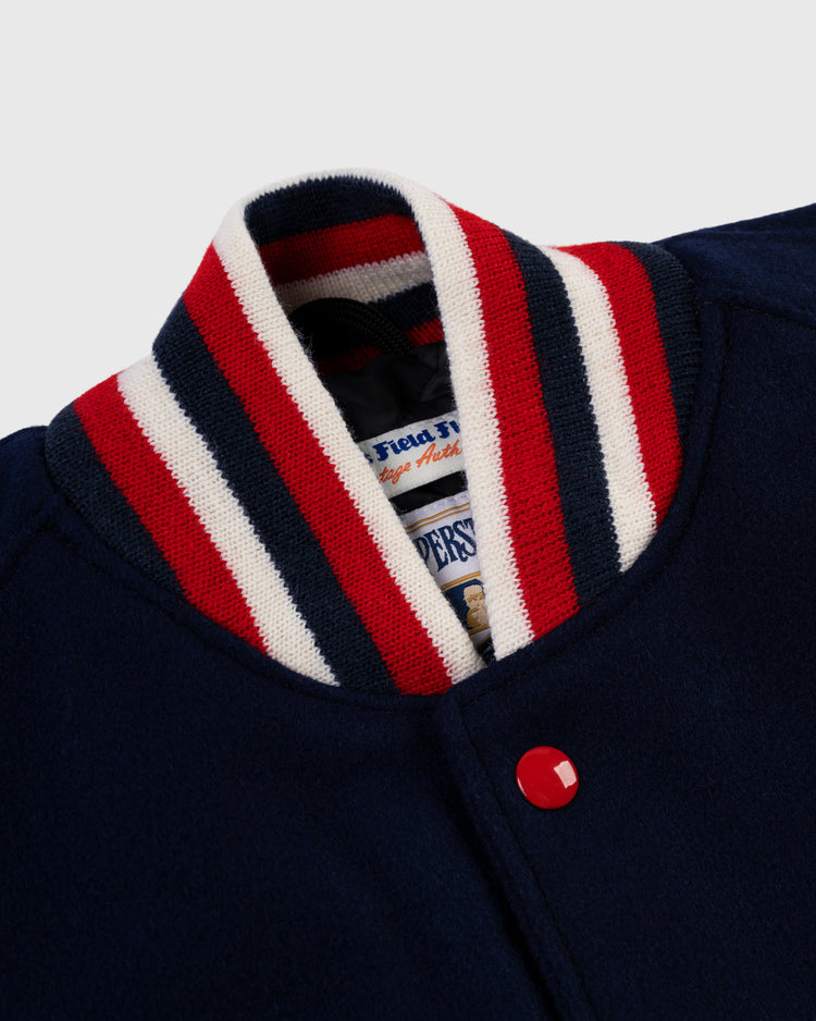 Close-up of the EFF St. Louis Cardinals 1950 Authentic All Wool Varsity Jacket in navy, featuring a ribbed collar with red, white, and navy stripes, a red snap button, and a glimpse of the vintage-style inner label.