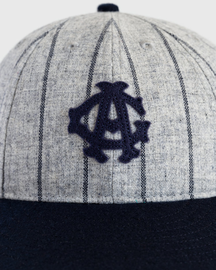 A close-up of the EFF Chicago American Giants 1914 Authentic Wool 8-Panel Softbrim Ballcap, featuring thin navy pinstripes, a navy interlocking logo on the front, and a solid navy brim.