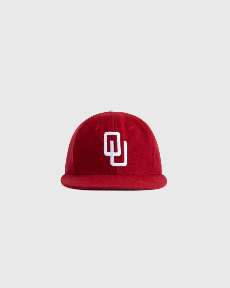 The EFF University of Oklahoma 1975 Authentic Wool Ballcap features a red design with a white interlocking OU logo, inspired by the classic Sooners cap and shown against a plain light gray background.