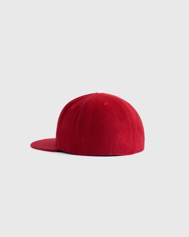 The EFF University of Oklahoma 1975 Authentic Wool Ballcap is shown from the side against a light gray background, featuring a plain red design with a flat brim and no visible logos or markings.