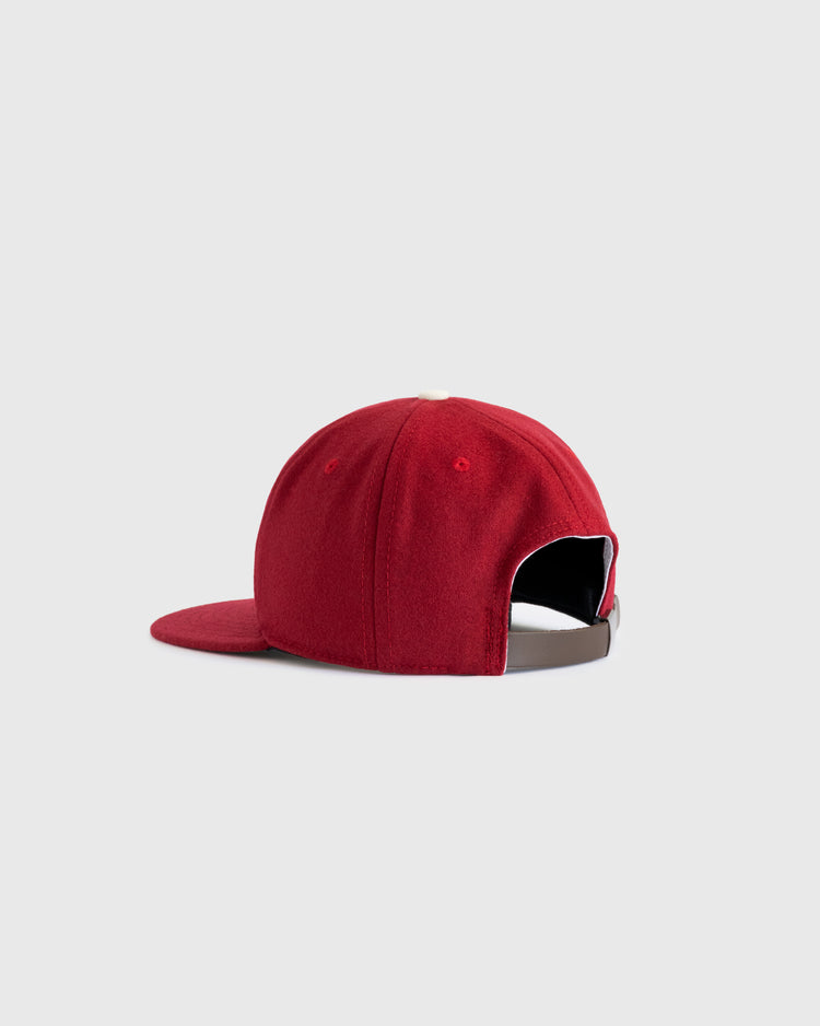 A red EFF University of Oklahoma 1975 Authentic Wool Ballcap, shown from the back with a curved brim and adjustable strap, evokes the classic College World Series cap. Set against a plain light gray background.