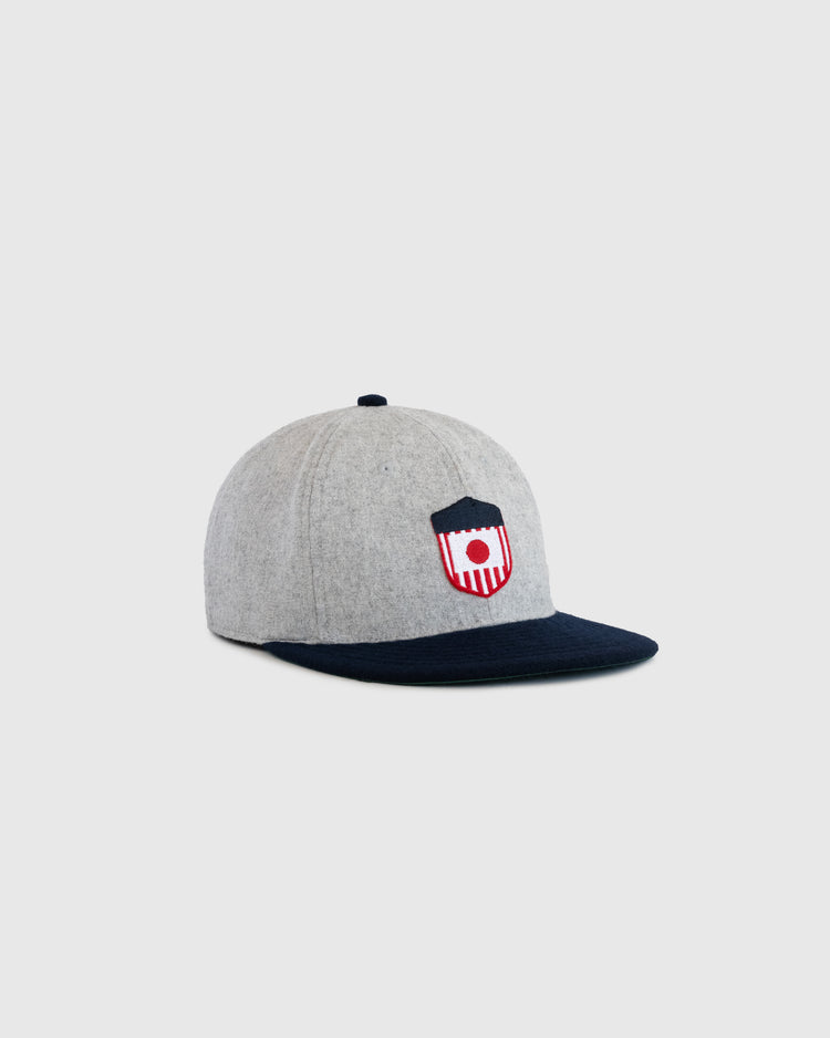 The EFF U.S. Tour of Japan 1922 Authentic Wool Ballcap features a gray crown, dark blue brim, and a red, white, and blue shield logo embroidery on the front, shown on a plain white background.