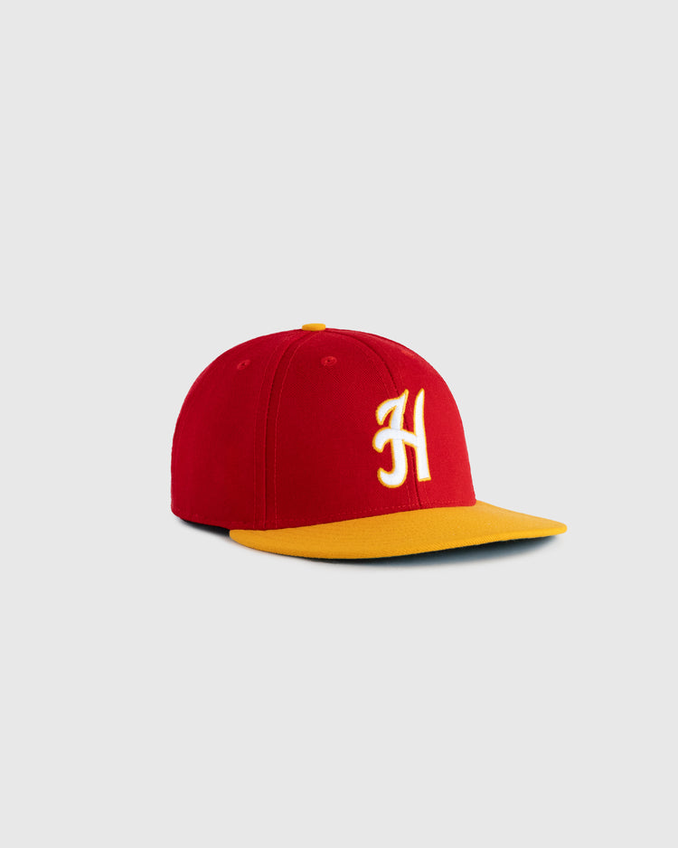 The EFF Hawaii Islanders 1986 Authentic Wool Ballcap, featuring a red crown, yellow brim, and white embroidered H, is shown on a light gray background.