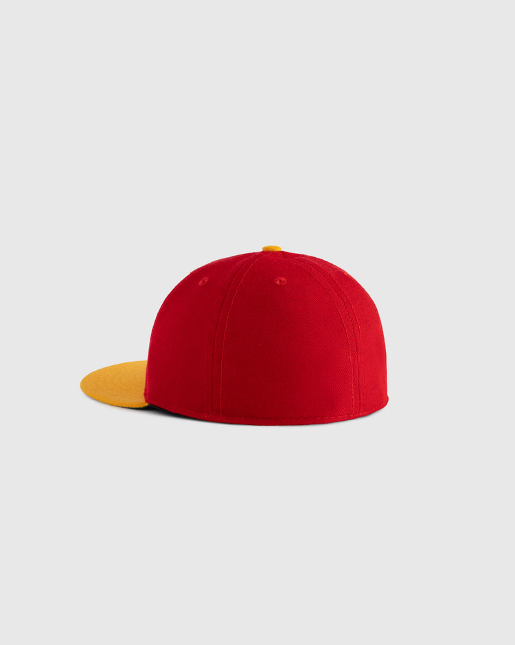 The EFF Hawaii Islanders 1986 Authentic Wool Ballcap in red with a yellow brim and top button is displayed on a plain light gray background, shown from the back and slightly to the side.