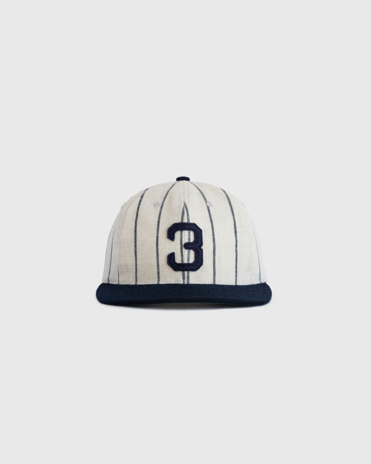 The Ebbets Field Flannels Babe Ruth 1932 Signature Series Wool Ballcap features thin vertical navy stripes, a bold navy number 3 on the front, and a solid navy brim, capturing classic Yankees style against a simple light background.