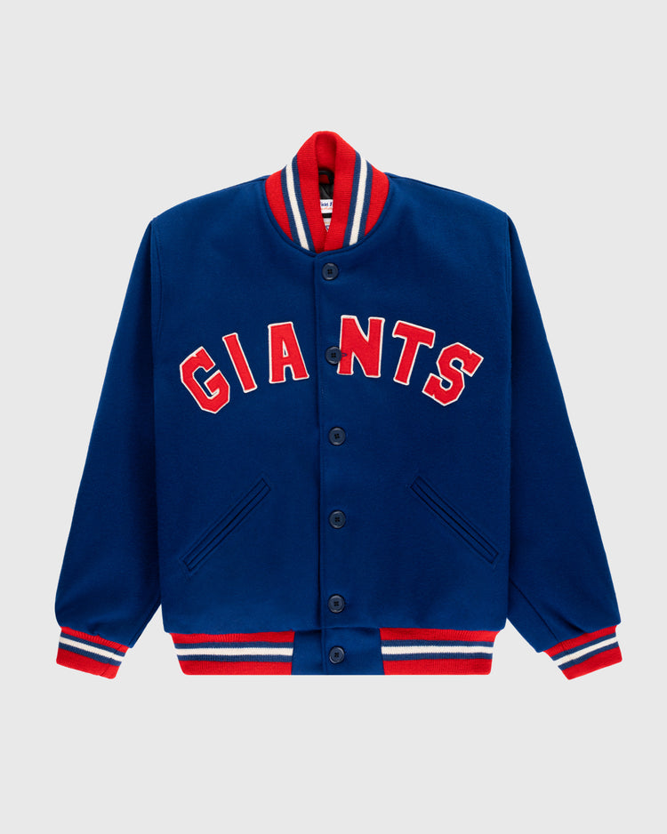 The EFF New York Giants 1932 Authentic All Wool Varsity Jacket features a blue body, red and white striped collar, cuffs, and hem, front buttons, two pockets, and GIANTS in bold red letters on the chest.