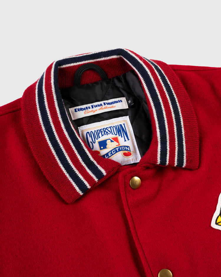 Close-up of an EFF St. Louis Cardinals 1940 Authentic Wool & Leather Jacket, featuring a ribbed red, white, and navy collar, gold snaps, and inside Ebbets Field Flannels and Cooperstown Collection labels.