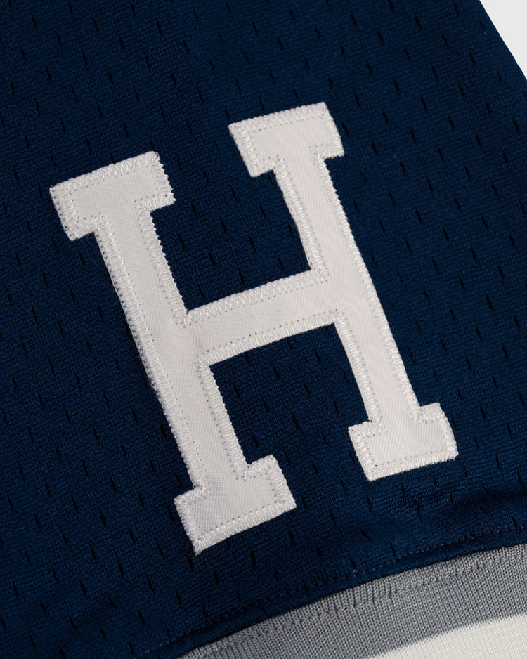 The EFF Homestead Grays Mesh V-Neck Jersey features a large white letter H stitched on dark blue perforated fabric, evoking classic baseball history and paying tribute to the iconic team’s throwback style.