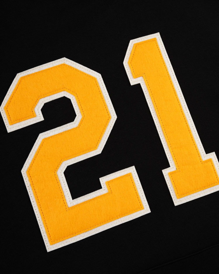 The EFF Roberto Clemente French Terry Feld Pullover Hoodie features a yellow number 21 with a white border, stitched onto black fabric—a tribute to Clemente’s legacy with the Pittsburgh Pirates.