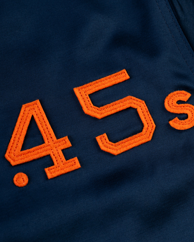 Close-up of orange .45s embroidery on dark blue fabric from the EFF Houston Colt .45s 1962 Satin Windbreaker Jacket.