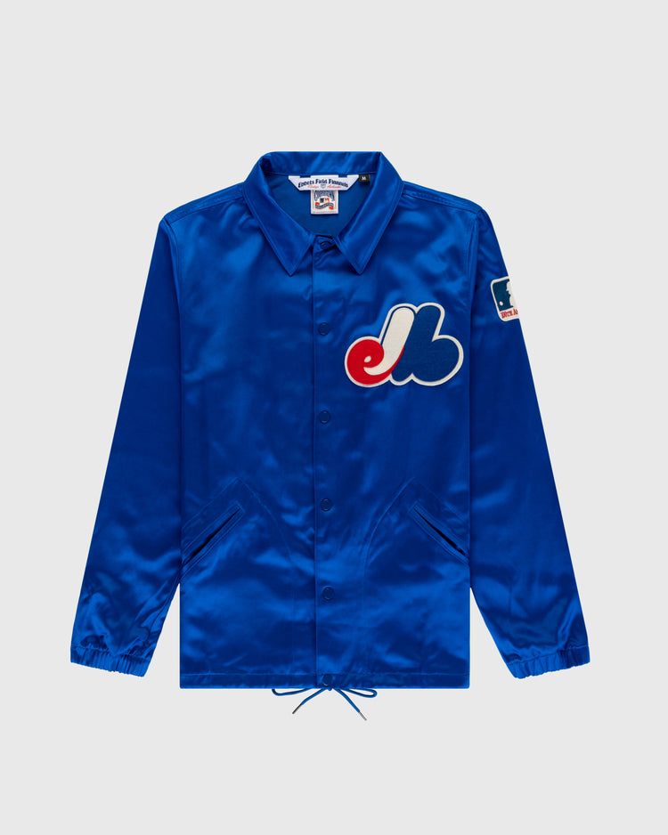The EFF Montreal Expos 1969 Satin Windbreaker is a royal blue vintage MLB jacket with front pockets, a large Expos logo on the chest, and a patch on the left sleeve, shown against a plain light background.
