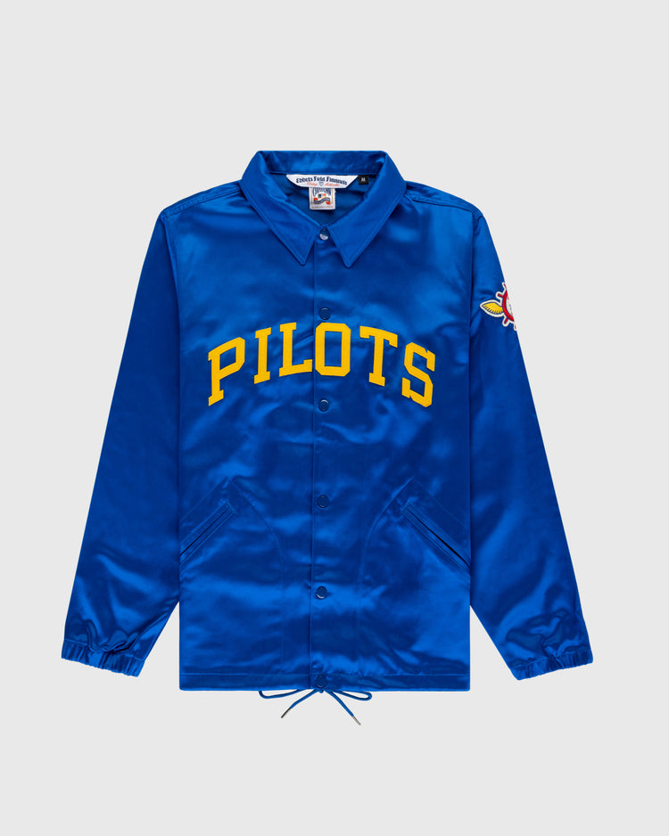 The EFF Seattle Pilots 1969 Satin Windbreaker Jacket features royal blue satin, yellow PILOTS lettering, a colorful pilot patch on the sleeve, plus classic details like a collar, snap buttons, and drawstrings at the hem.