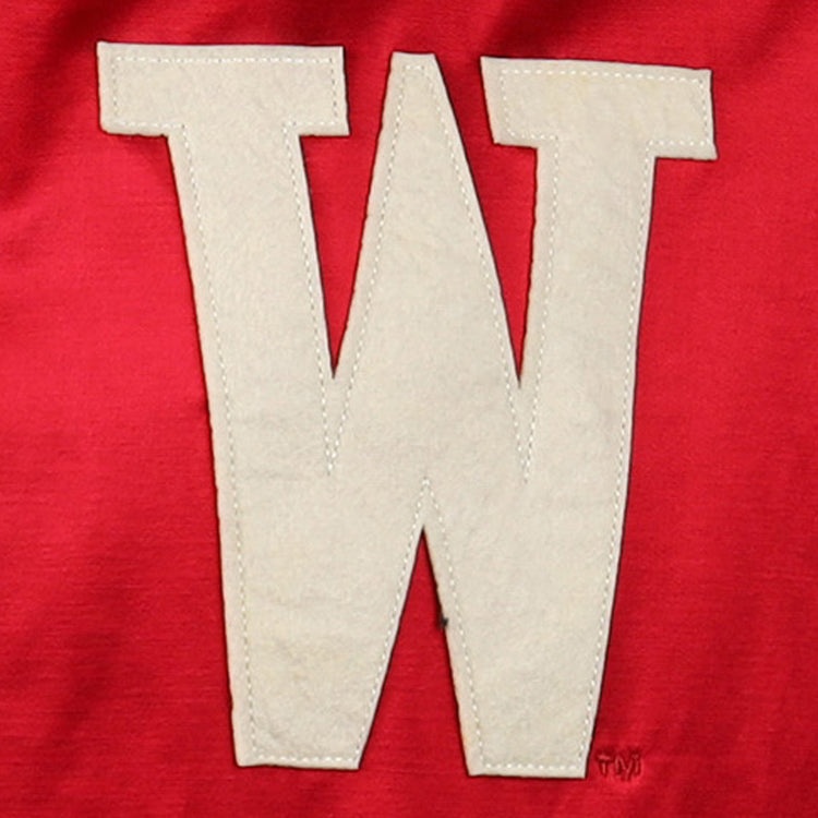 A bold white W is stitched on red satin fabric, capturing the classic look of the University of Wisconsin Satin Windbreaker by EFF.