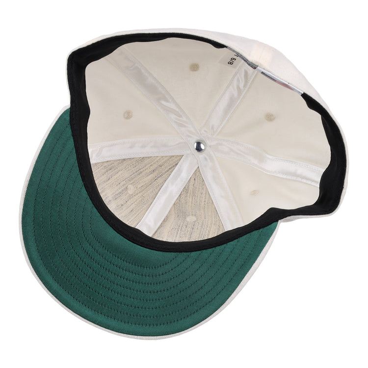 The image shows the inside of an EFF Cream Wool Vintage Ballcap, featuring a green underbrim, black inner band, visible stitching and seams, and a silver button at the crown of this classic cap.