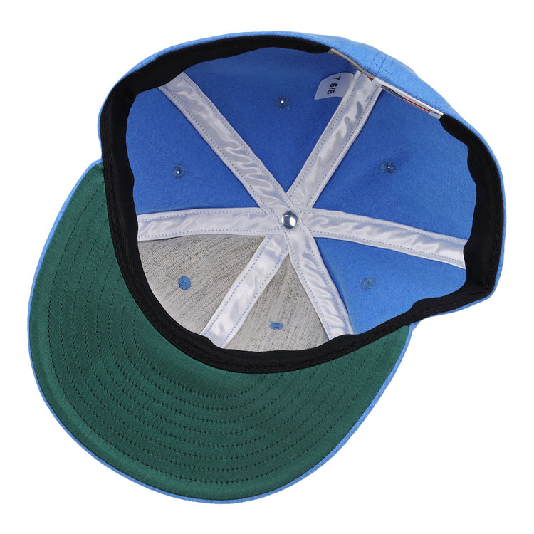 An inside view of the Columbia Blue Wool Vintage Ballcap by EFF reveals its green brim, fabric lining, detailed stitching, and inner size tag—all showcasing classic American-made style.