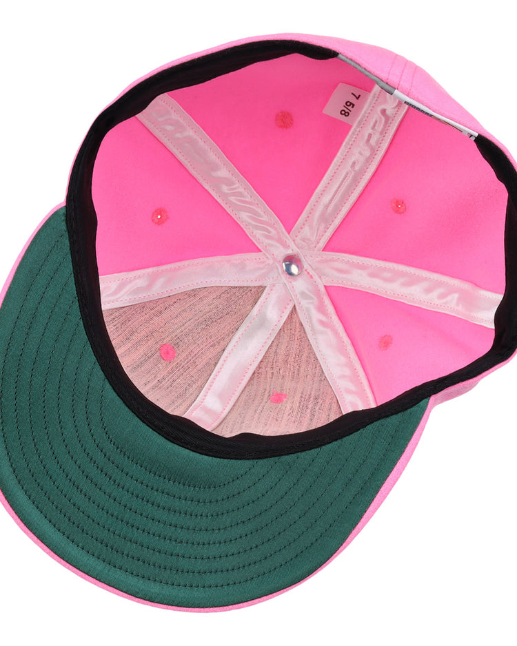 Interior view of the EFF Pink Wool Vintage Ballcap featuring a green underbrim, pink stitching, and a size tag marked 7 3/8.