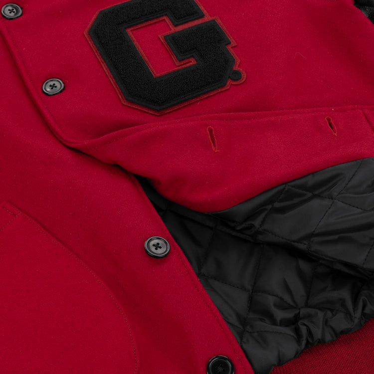 Close-up of the EFF University of Georgia 1939 Authentic Jacket featuring black buttons, quilted black lining, and a large black letter G patch on the chest.
