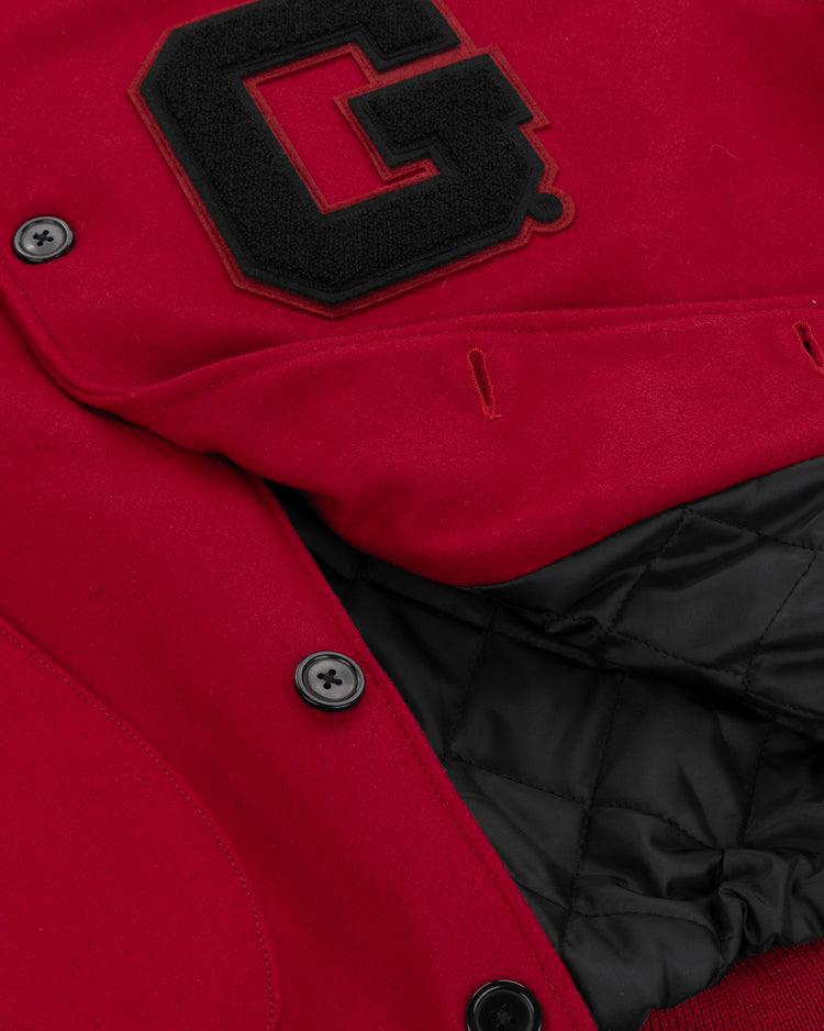 Close-up of the EFF University of Georgia 1939 Authentic Jacket featuring black buttons, quilted black lining, and a large black letter G patch on the chest.