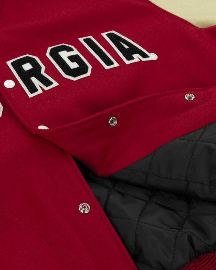 A close-up of the EFF University of Georgia 1966 Authentic Jacket, featuring bold black-and-white GEORGIA lettering and an open front that reveals its black quilted lining.
