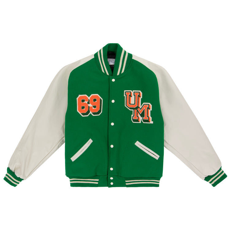The EFF University of Miami 1969 Authentic Jacket features green body, white sleeves, striped cuffs and collar, snap buttons, and orange “69” and UM patches on the chest—perfect for a classic Miami varsity look.