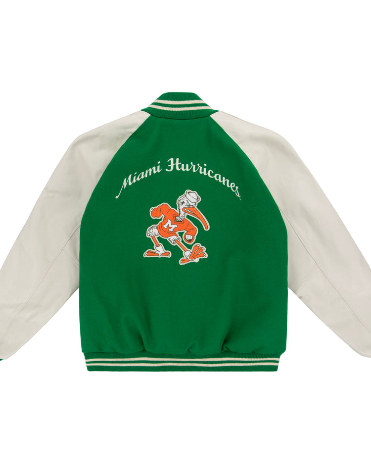 Show your Hurricane pride with the EFF University of Miami 1969 Authentic Jacket—green and white, featuring Miami Hurricanes above the ibis mascot in an orange sweater with a white M.