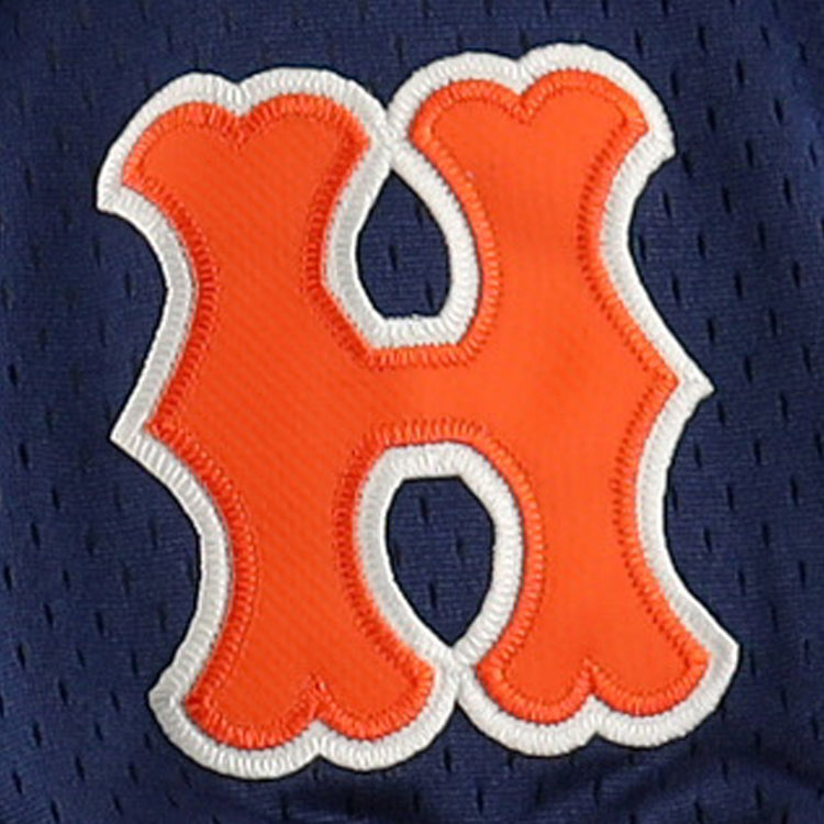 An orange, bubble-shaped H with a white outline is stitched onto dark blue mesh, echoing vintage styles on the EFF Hiroshima Carp EFF DNA Replica V-Neck Mesh Jersey.