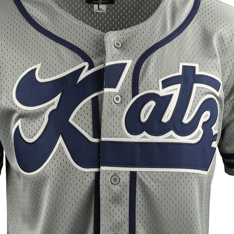Close-up of the Kansas City Katz EFF DNA Replica Button-Up Mesh Jersey by EFF, featuring gray mesh with navy trim, buttons, and bold Kats script—a tribute to Kansas Citys historic Katz Drugstore and Ban Johnson Baseball League.